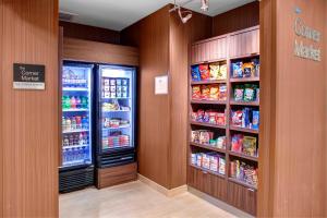 a grocery store aisle with two refrigerators and shelves of food at Fairfield Inn & Suites by Marriott Atlanta Stockbridge in Stockbridge