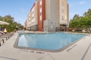 a swimming pool in front of a building at SpringHill Suites by Marriott Houston The Woodlands in The Woodlands