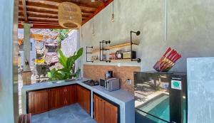 eine Küche mit einer Spüle und einer Theke mit einem Aquarium in der Unterkunft The Lavana Villa Sutji Sanur in Sanur