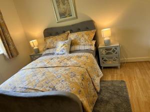 a bedroom with a bed with two night stands and two lamps at Modern Spacious Gated Two Bedrooms Apartment in Stifford