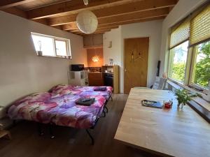 a bedroom with a bed and a table in it at B&B 't Buitenkansje in Almere