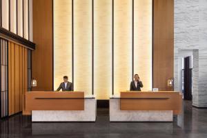 two men sitting at desks in a lobby at Fairfield by Marriott Hangzhou Xiaoshan in Hangzhou