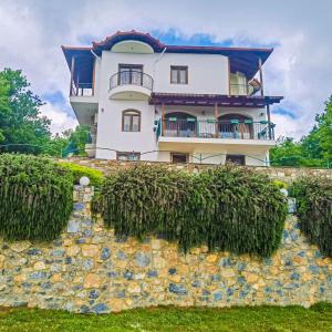 a building on top of a stone wall at Villa Etheras - Nested between Nature by Amazing View - 5 mins from Edessa in Edessa