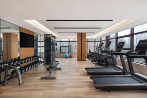 a gym with a row of treadmills and machines at Fairfield by Marriott Hangzhou Xiaoshan in Hangzhou