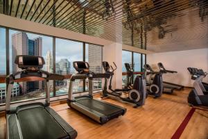 a gym with cardio machines and a view of the city at The Plaza Hotel Columbus at Capital Square in Columbus