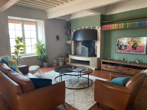a living room with a couch and a table at Les Cimes du Puy-en-Velay in Le Puy-en-Velay