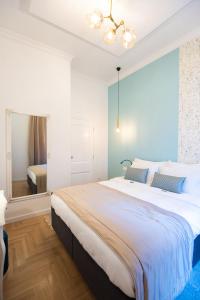 a bedroom with a large bed and a mirror at Luxury Suite in City Centre in Sarajevo
