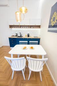 a kitchen with a white table and two chairs at Luxury Suite in City Centre in Sarajevo