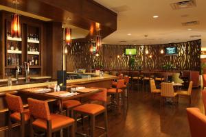 a restaurant with tables and chairs and a bar at Marriott El Paso in El Paso