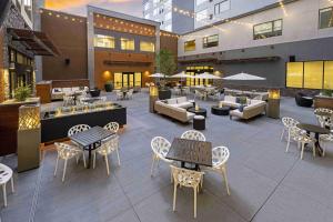 a patio with tables and chairs and a restaurant at SpringHill Suites by Marriott Colorado Springs Downtown in Colorado Springs