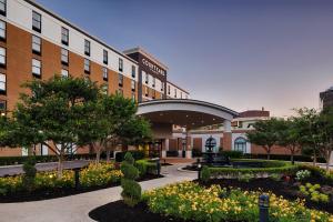a building with a courtyard with flowers and trees at Courtyard by Marriott Springfield Downtown in Springfield