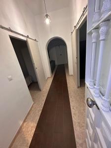 a hallway with a hallway leading to a hallwayasteryasteryasteryasteryasteryasteryastery at La casa de la Abuela in Málaga