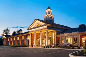 a building with a clock tower on top of it at Reikart House Buffalo, a Tribute Portfolio Hotel in Amherst