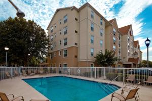 a swimming pool in front of a building at TownePlace Suites by Marriott Orlando East/UCF Area in Orlando