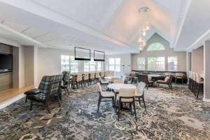 a conference room with tables and chairs and a tv at Residence Inn by Marriott Denver Golden/Red Rocks in Golden