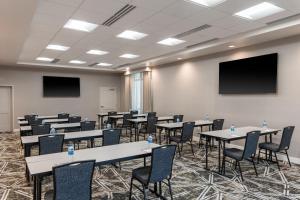 a conference room with tables and chairs and a screen at Residence Inn by Marriott Lancaster Palmdale in Lancaster +36 photos