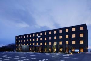 a building with a parking lot in front of it at Fairfield by Marriott Nara Tenri Yamanobenomichi in Tenri