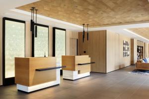 a lobby with wooden furniture and windows at Fairfield by Marriott Nara Tenri Yamanobenomichi in Tenri