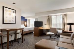 a hotel room with a bed and a living room at Residence Inn By Marriott Vacaville in Vacaville