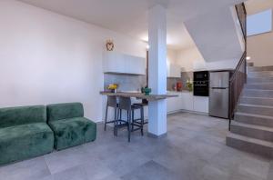 馬爾薩拉的住宿－Casa B, Room 1 - Palm Kite Paradise，一间带绿色沙发的客厅和一间厨房
