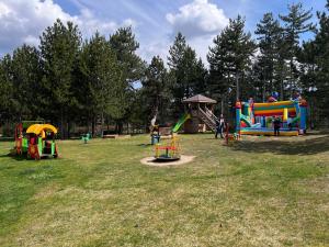 a park with several playground equipment in a field at Pirin Golf Villa Compass Property in Bansko