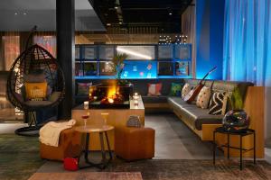 a living room with a couch and a fire place at Moxy Milton Keynes in Milton Keynes