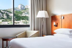 a hotel room with two beds and a window at Riviera Marriott Hotel La Porte De Monaco in Cap d'Ail