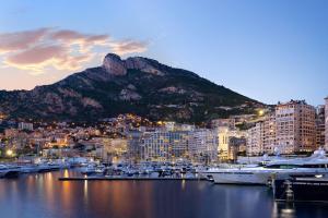 a view of a city with boats in a harbor at Riviera Marriott Hotel La Porte De Monaco in Cap d'Ail