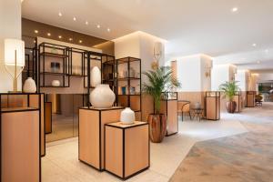 a lobby with vases on display in a building at Riviera Marriott Hotel La Porte De Monaco in Cap d'Ail
