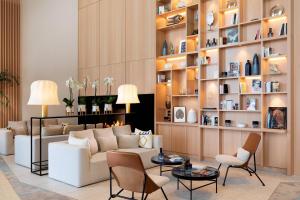 a living room with a white couch and chairs at Riviera Marriott Hotel La Porte De Monaco in Cap d'Ail