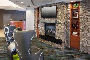 a waiting room with a fireplace and a tv at Residence Inn by Marriott Dothan in Dothan