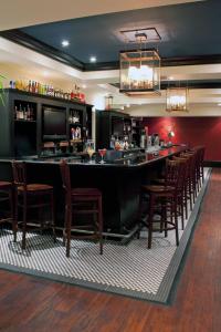 a bar with a row of chairs in a restaurant at Sheraton Columbia Downtown Hotel in Columbia