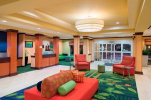 a lobby of a hospital with red chairs and a couch at Fairfield Inn & Suites Huntingdon Raystown Lake in Huntingdon