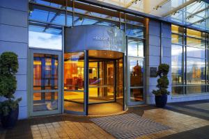 an entrance to a building with a revolving door at Sheraton Poznan Hotel in Poznań