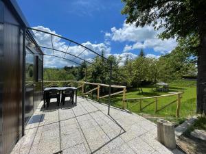 a patio with two tables on the side of a house at I Falchi Pellegrini - Bungalow e Tenda in Monzuno