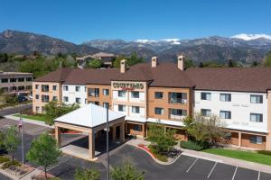 an aerial view of a hotel with mountains in the background at Courtyard by Marriott Colorado Springs South in Colorado Springs