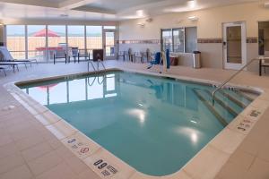 a large swimming pool in a hotel lobby at Courtyard by Marriott Elmira Horseheads in Horseheads