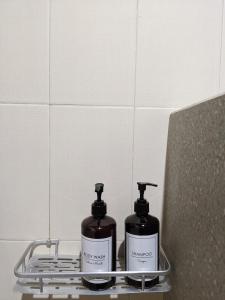 two bottles of soap sitting on a rack in a bathroom at Ubud Dream in Ubud