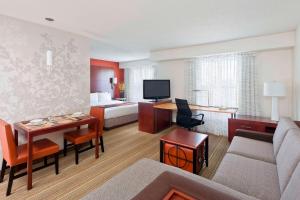a hotel room with a bed and a living room at Residence Inn by Marriott Waco in Waco