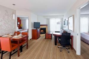 a hotel room with a dining table and a bedroom at Residence Inn by Marriott Waco in Waco