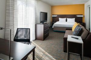 a hotel room with a bed and a television at Residence Inn by Marriott Long Beach in Long Beach
