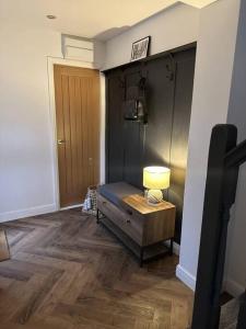 a room with a table with a lamp and a door at Cottage/boutique style - Free parking & Wi-Fi in Hull