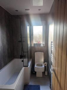 a bathroom with a toilet and a bath tub at Cottage/boutique style - Free parking & Wi-Fi in Hull