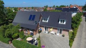 an aerial view of a house with a solar roof at Aloha 1 in Neue Tiefe Fehmarn