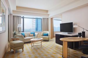 a hotel room with a living area with a flat screen tv at JW Marriott Hotel Beijing in Beijing