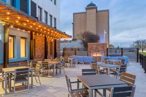 an outdoor patio with tables and chairs and lights at Fairfield Inn & Suites by Marriott Des Moines Downtown in Des Moines