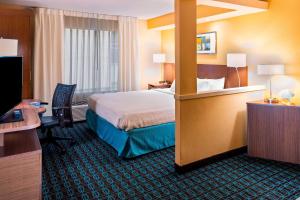 a hotel room with a bed and a desk at Fairfield Inn & Suites by Marriott Atlanta Buckhead in Atlanta