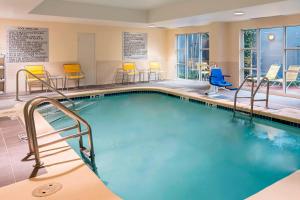 a pool with chairs and chairs in a hotel room at Fairfield Inn & Suites by Marriott Atlanta Buckhead in Atlanta