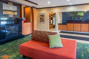 a living room with a couch and a fireplace at Fairfield Inn & Suites Canton in North Canton