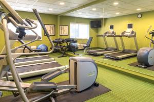 a gym with treadmills and ellipticals in a room at Fairfield Inn & Suites Canton in North Canton
